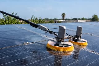 Motorised double-disc brush in use on solar panels
